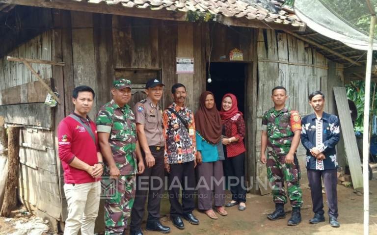 Petugas Pasang Stiker di Rumah Penerima PKH 