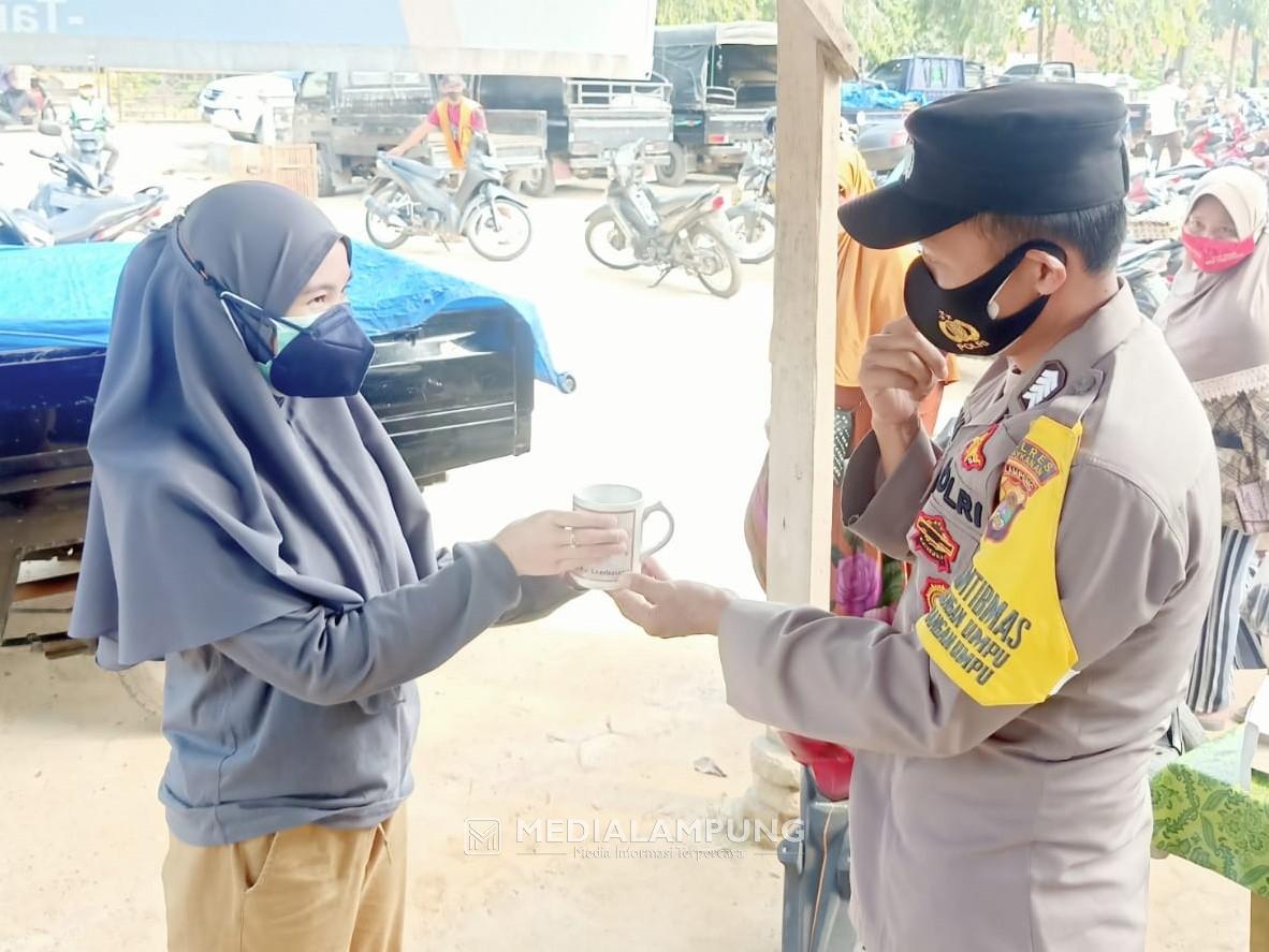 Bhabinkamtibmas Polres Waykanan Bagikan Souvenir dan Masker di Pasar Blambangan Umpu